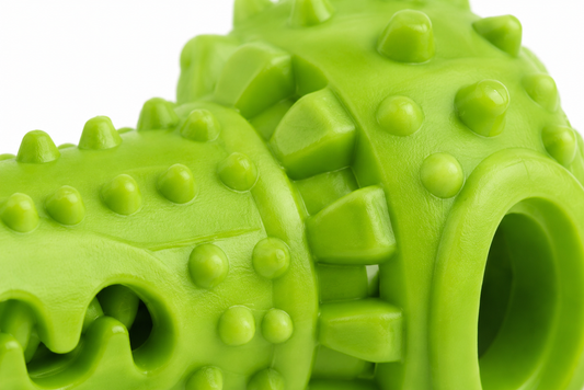Close-up view of two interlocking bright green plastic gear-like toys