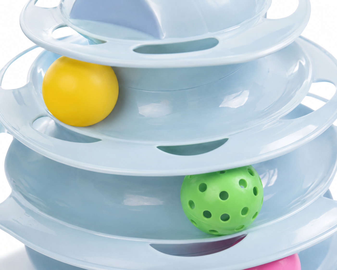 Colorful plastic ball tower toy with yellow and green balls in motion