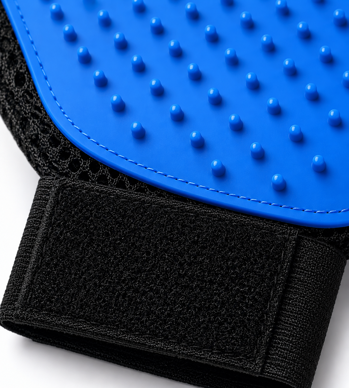 Close-up of a blue and black textured pet grooming glove with strap