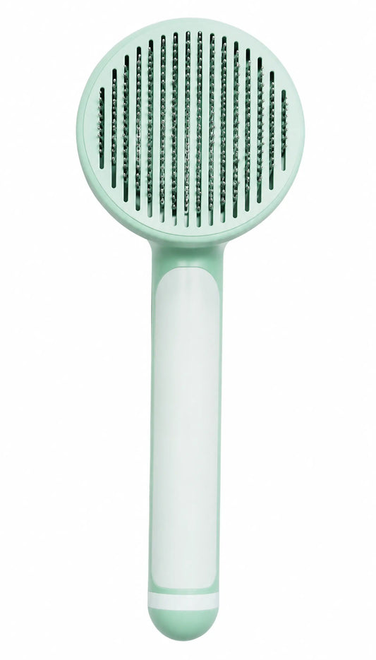 Mint-green baby hairbrush with white handle and soft bristles on white