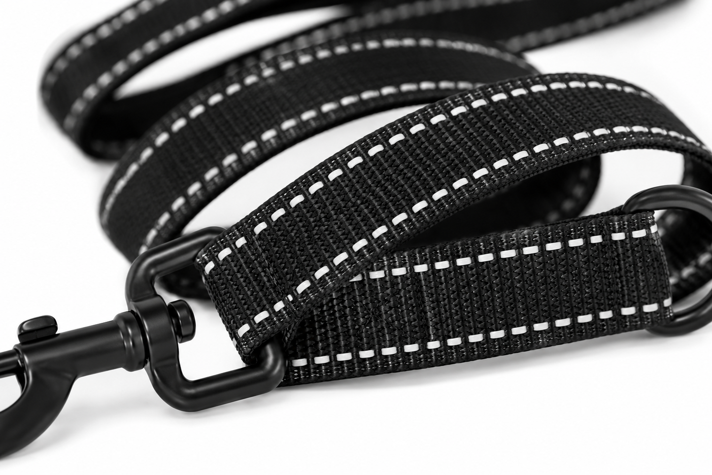 Close-up view of a sturdy black dog leash with reflective stitching and metal